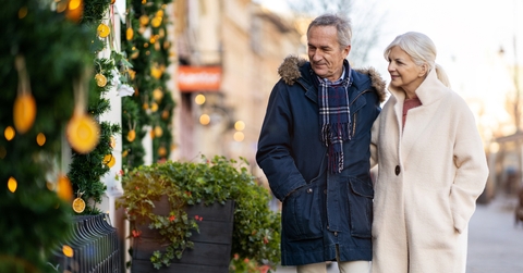 senior couple walking on the city street at winter day