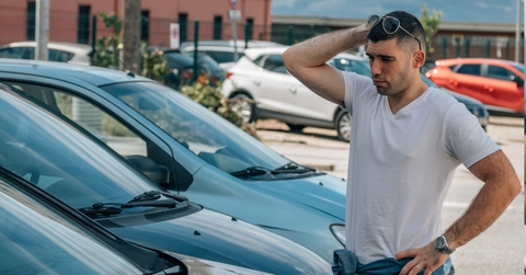 man standing at automobile dealership