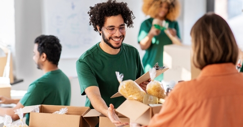 young teenagers in warehouse packing donation boxes for charity