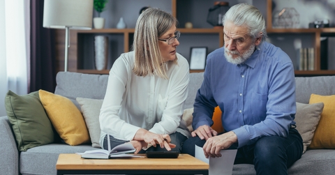senior couple preparing tax report at home 