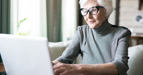 senior woman wearing eyeglasses sitting at cafe