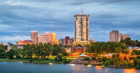 beautiful view of lake with a row of trees and majestic buildings in the background at Tulsa, Oklahoma, USA
