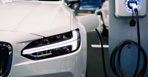 An environmentally-friendly vehicle hybrid electric car's battery is being charged by a sustainable energy source. .