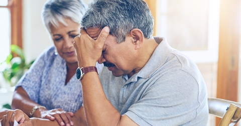 An elderly man and woman express concern