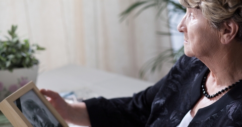 senior widow reminiscing her husband