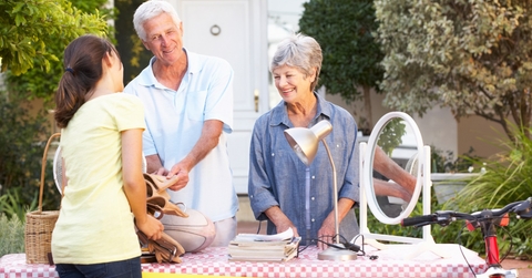 senior couple holding yard sale outdoor