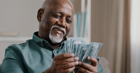 elderly man counting money