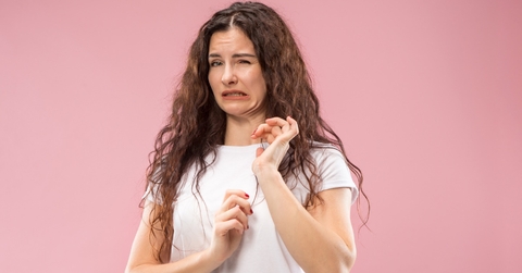 woman disgusted over pink backdrop