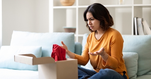  Woman looking at cardboard box 