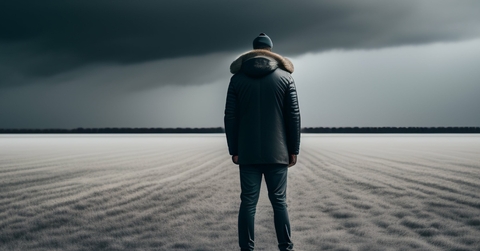 young man standing in empty field