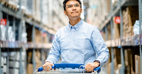man walking with trolley in warehouse