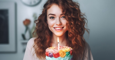 beautiful woman holding cake with candle