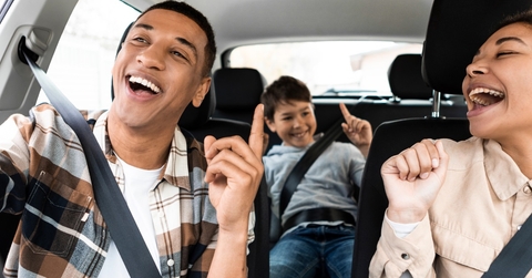 Happy family singing on road trip