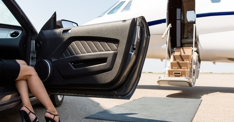 wealthy woman stepping out of car
