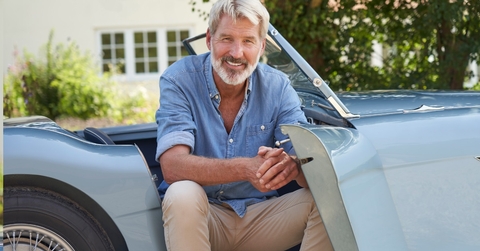 senior man in vintage sports car
