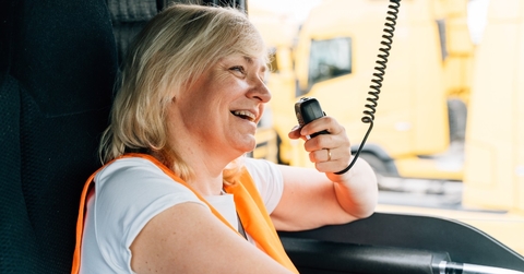 female truck driver talking by radio