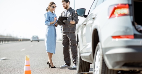highway worker signing papers with woman