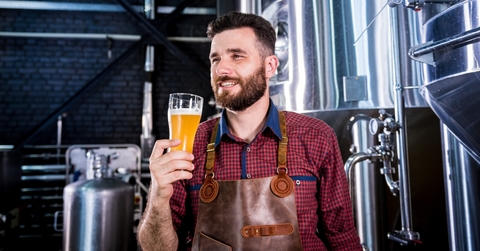 young brewer wearing a leather apron