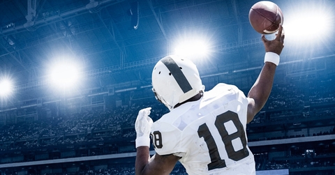 quarterback throwing football in professional game