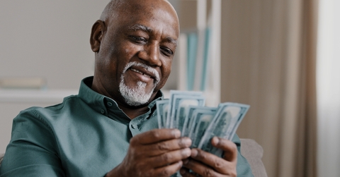 senior man counting banknotes