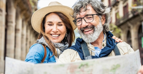 senior couple reviewing map while traveling