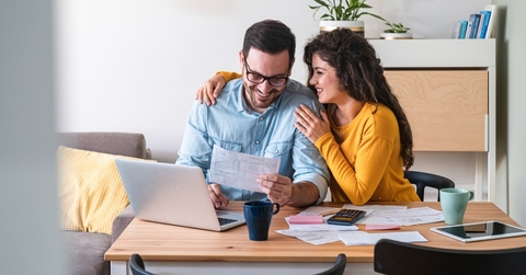happy couple paying bills online