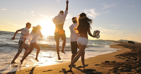 group of friends playing on beach