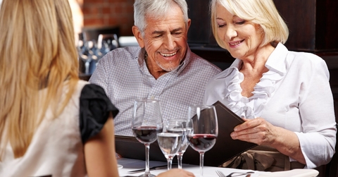 senior couple with daughter at restaurant