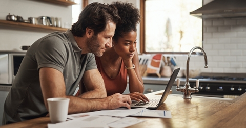 couple financial planning in a kitchen