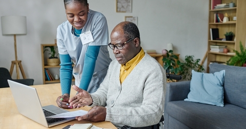 young caregiver helping senior man