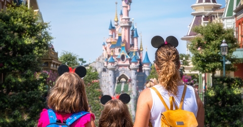 family gazing castle in disneyland
