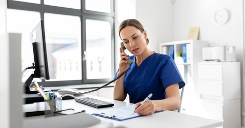 female nurse on phone at work