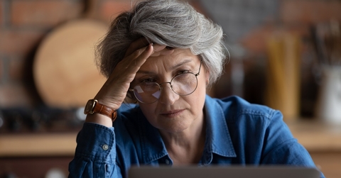 confused senior woman using laptop