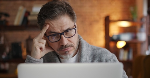 senior man stressed at laptop screen