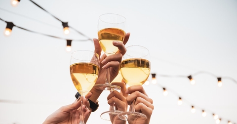 people celebrating together with wine glasses