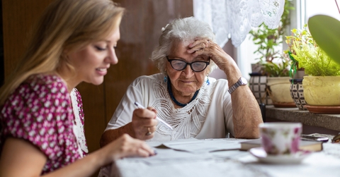 woman helping elderly grandmother