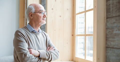 senior man gazing through window