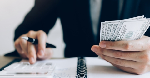businessman calculating investment at work