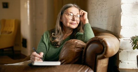 retired female in stylish round glasses