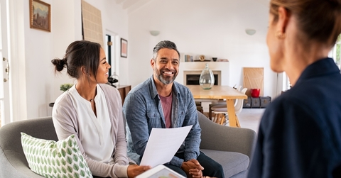 mature couple consulting female finance advisor