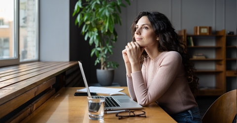 woman thinking about goals at desk