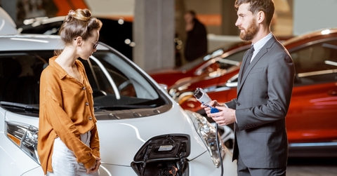 sales manager showing electric car
