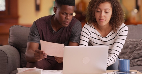 african american couple reviewing bills together