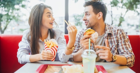 couple eating fast food at restaurant