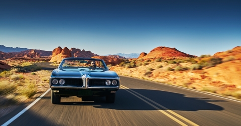 man driving vintage car
