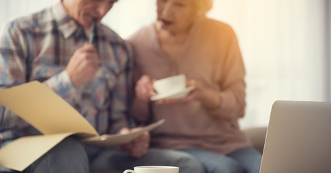 senior couple reviewing documents at home