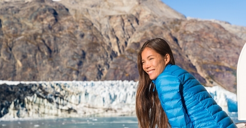 tourist looking at glacier from cruise