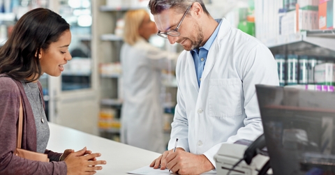 writing prescription at pharmacy