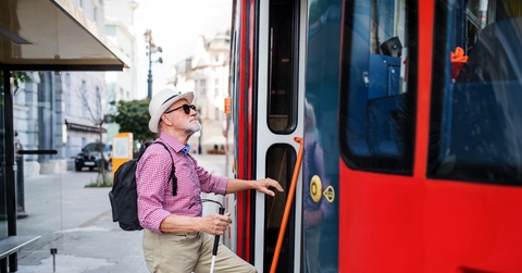 senior blind man using public transport
