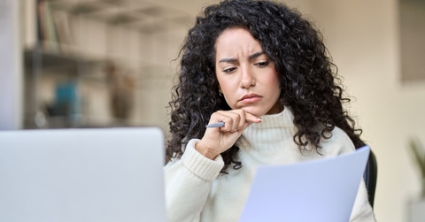 worried female accountant reviewing data
